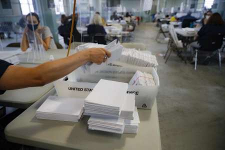 Image of ballot worker sorting mail in ballots